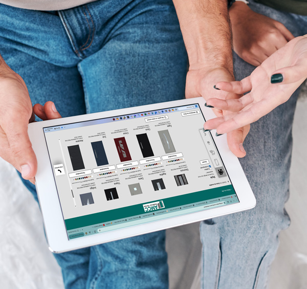 zoom sur les mains d'un couple installé dans le salon chez eux en train de configurer leur porte d'entrée sur le configurateur AMCC sur leur tablette